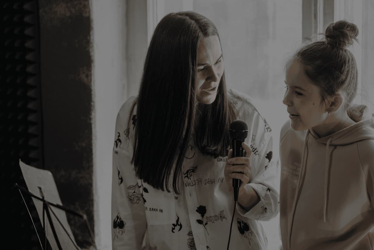 A voice coach working one-on-one with a student